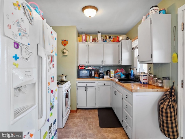 kitchen with sink, white appliances, white cabinets, and backsplash