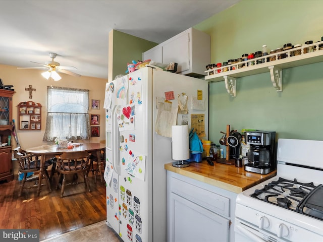 kitchen featuring white cabinetry, hardwood / wood-style floors, ceiling fan, and white appliances