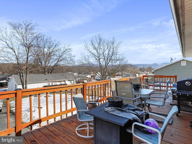 snow covered deck featuring a grill