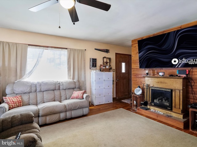 living room featuring dark hardwood / wood-style flooring and ceiling fan