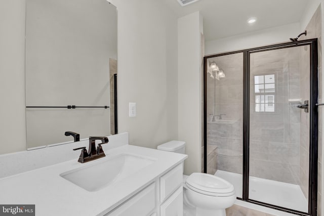 bathroom featuring vanity, toilet, and walk in shower