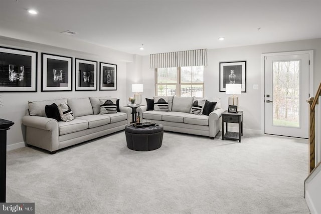 living room with plenty of natural light and light colored carpet