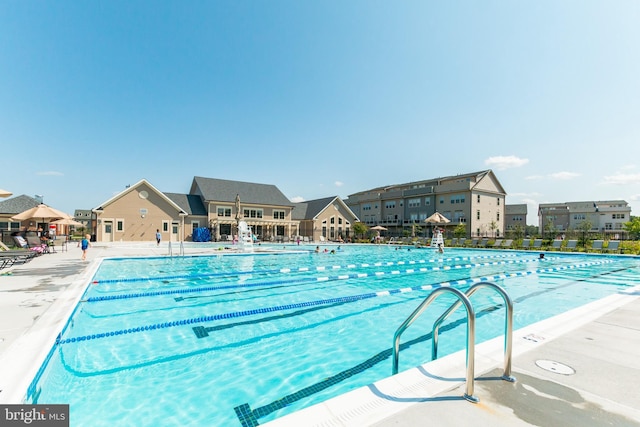 view of swimming pool featuring a patio and pool water feature