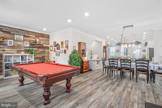 recreation room with hardwood / wood-style floors, pool table, ornamental molding, and wood walls