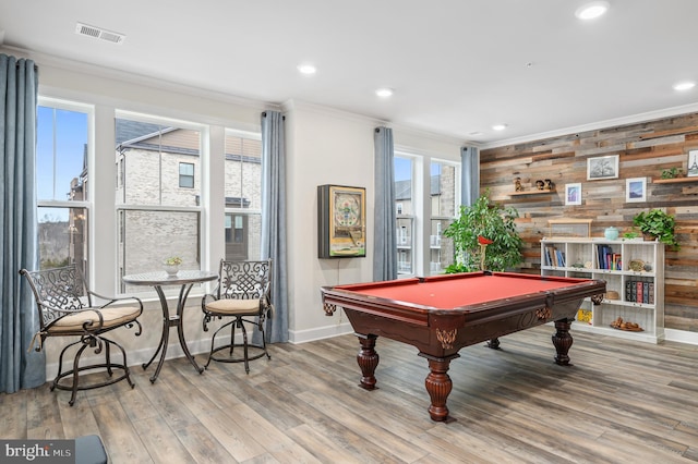 game room with crown molding, pool table, wooden walls, and light hardwood / wood-style floors