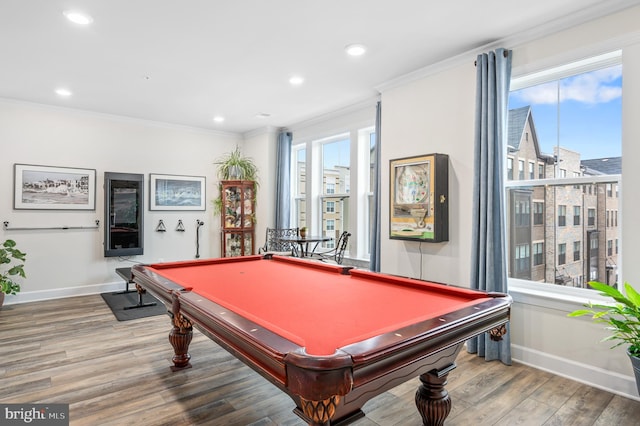 rec room with crown molding, wood-type flooring, and a wealth of natural light