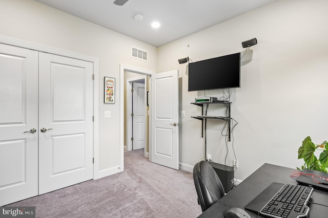 carpeted office space with ceiling fan, visible vents, and baseboards