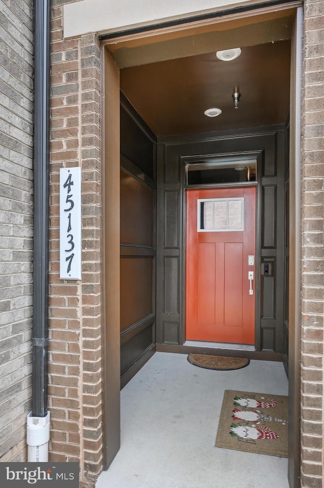 property entrance with brick siding