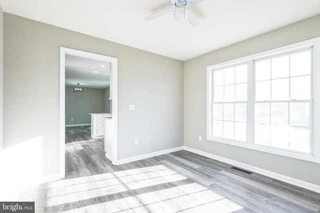 unfurnished room featuring hardwood / wood-style floors and ceiling fan