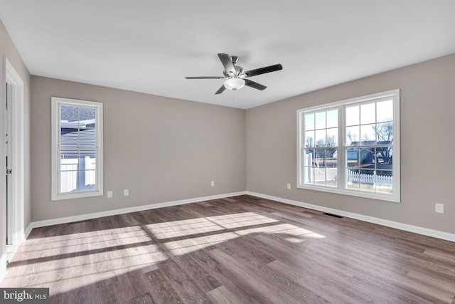 spare room featuring hardwood / wood-style flooring and ceiling fan