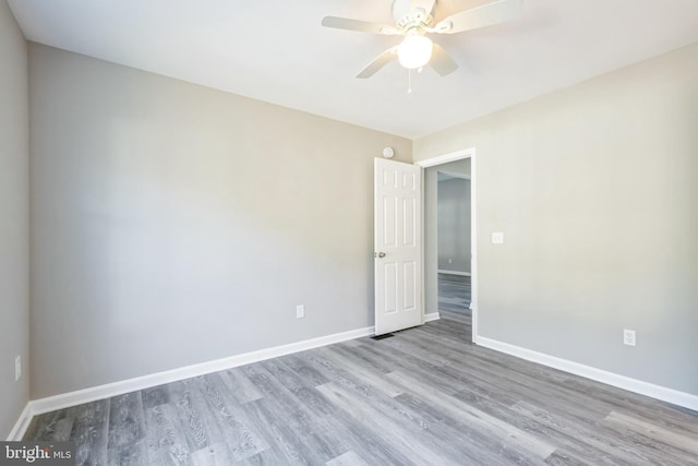 unfurnished room featuring ceiling fan and light wood-type flooring