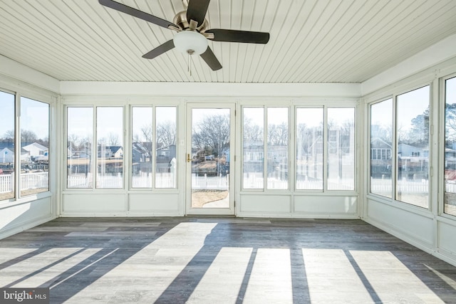 unfurnished sunroom featuring ceiling fan