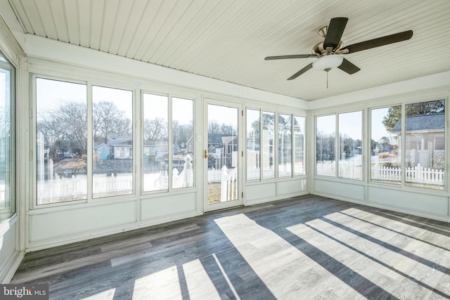 unfurnished sunroom with a water view and ceiling fan