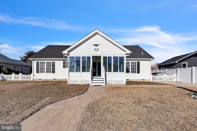 view of front facade featuring a front lawn and a sunroom