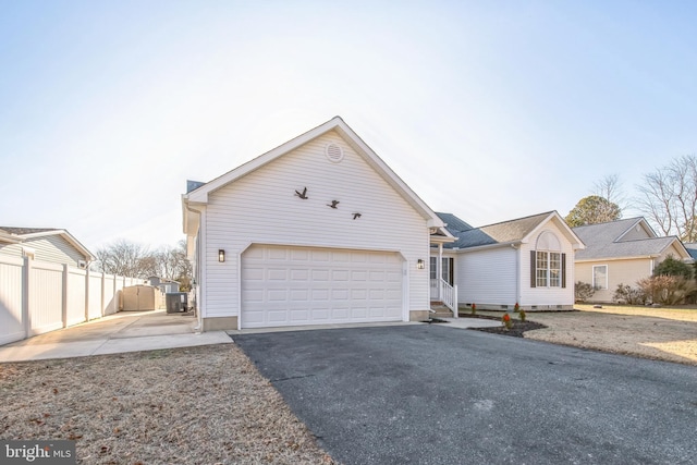 view of front of property featuring cooling unit and a garage