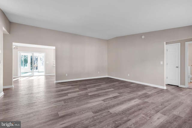 empty room with hardwood / wood-style flooring