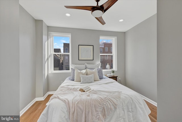 bedroom with ceiling fan and light hardwood / wood-style flooring