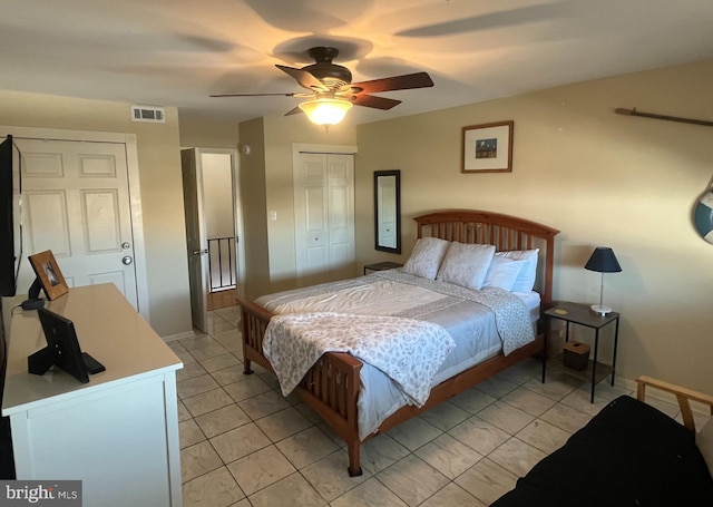 tiled bedroom featuring a closet and ceiling fan