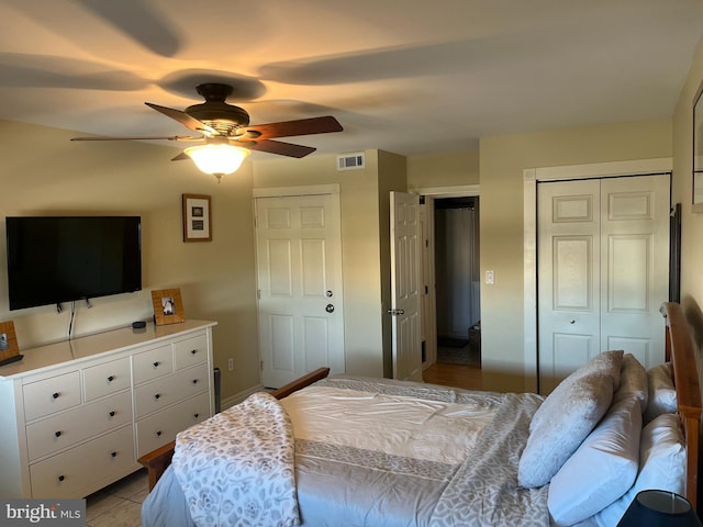 tiled bedroom featuring ceiling fan