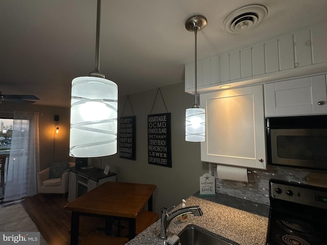 kitchen with white cabinetry, sink, decorative backsplash, electric range, and light stone countertops