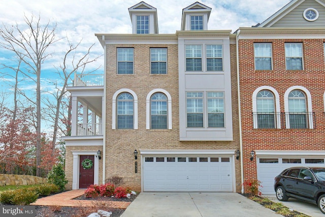 view of property featuring a garage and a balcony