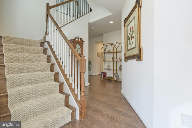 stairway with hardwood / wood-style floors