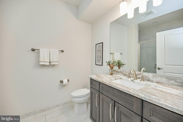 bathroom featuring an enclosed shower, vanity, and toilet