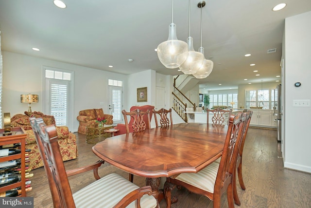 dining room with plenty of natural light and dark wood-type flooring