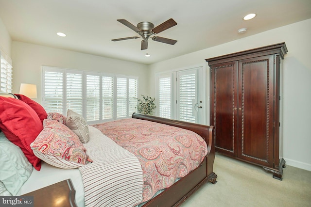 carpeted bedroom featuring multiple windows and ceiling fan