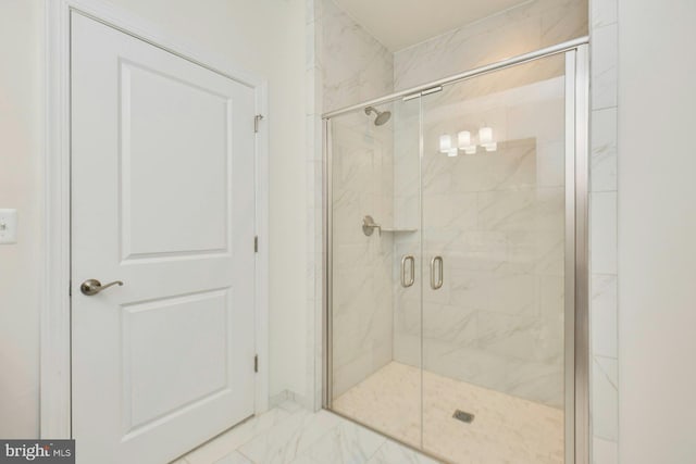 bathroom featuring a shower with shower door