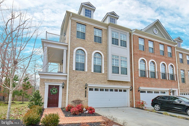 multi unit property featuring a balcony and a garage