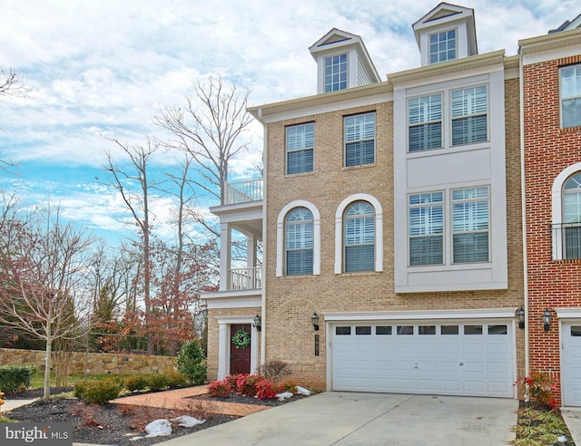 view of property featuring a balcony and a garage