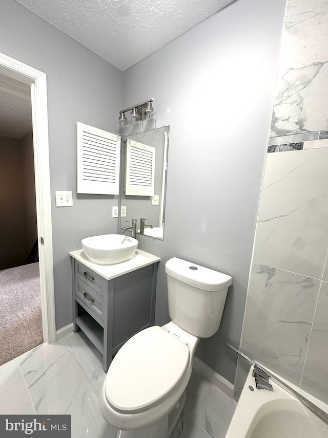 bathroom with vanity, toilet, radiator, and a textured ceiling