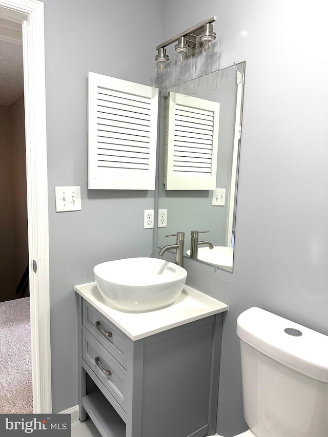 bathroom with vanity and toilet