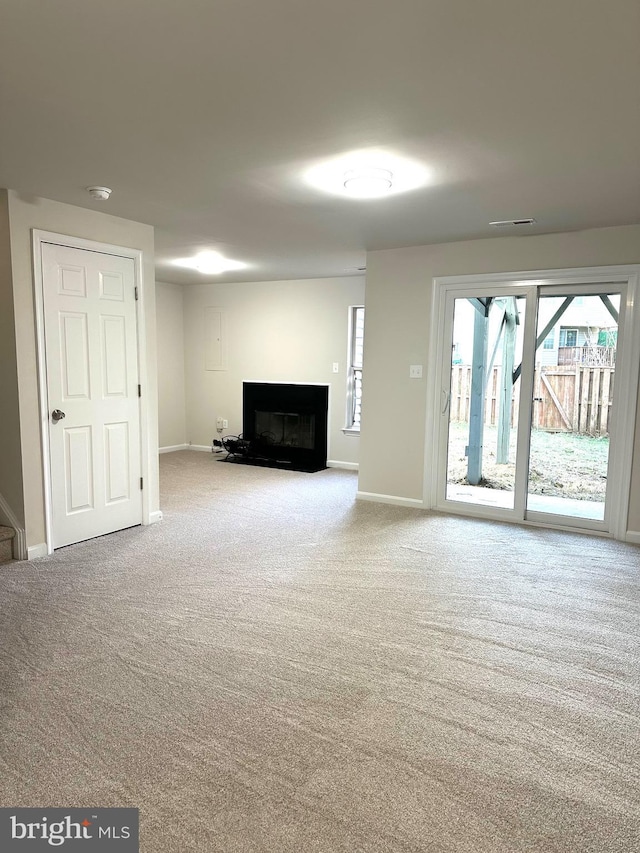 unfurnished living room with light colored carpet