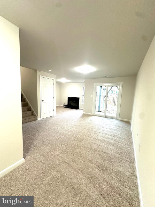 unfurnished living room featuring carpet