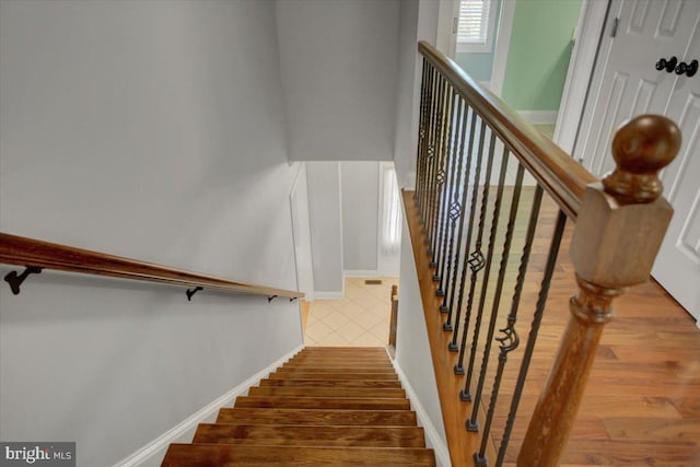 stairway featuring hardwood / wood-style floors