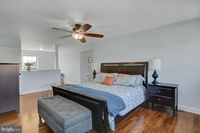 bedroom with ceiling fan and dark hardwood / wood-style floors