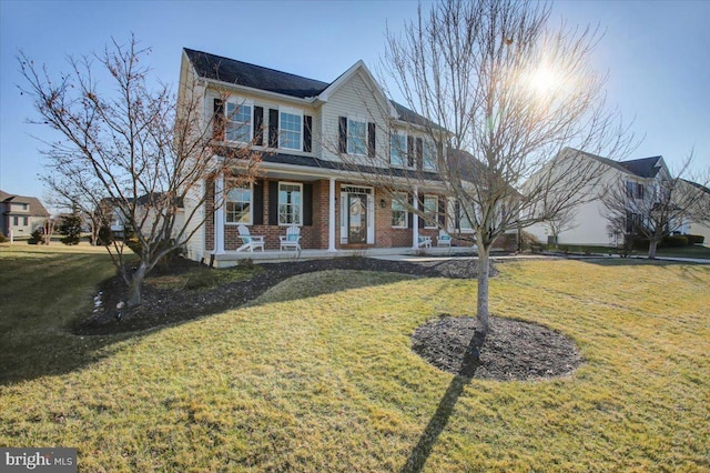 view of front facade with a front lawn and covered porch