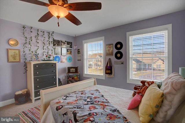 bedroom featuring ceiling fan and carpet