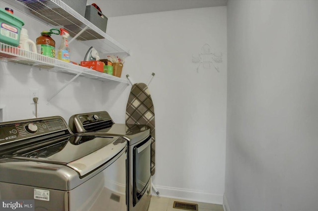 laundry area featuring washing machine and clothes dryer