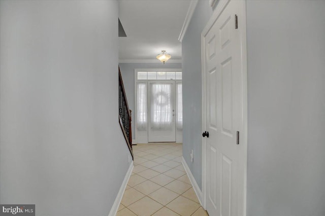 corridor featuring ornamental molding and light tile patterned flooring