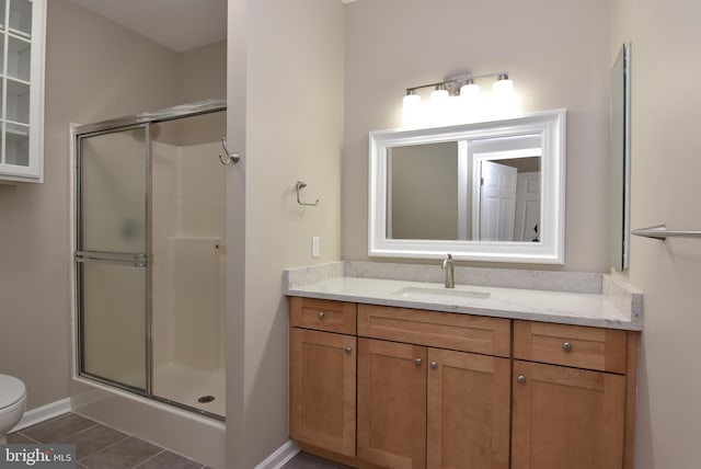 bathroom featuring walk in shower, tile patterned floors, toilet, and vanity