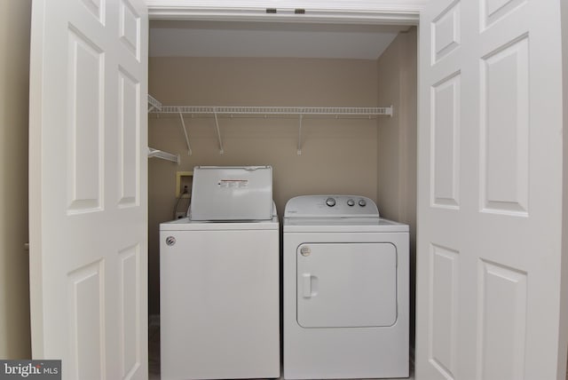 clothes washing area with independent washer and dryer