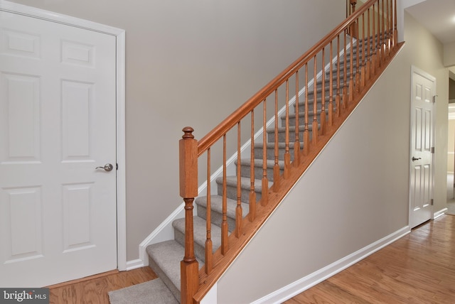 stairway with hardwood / wood-style flooring