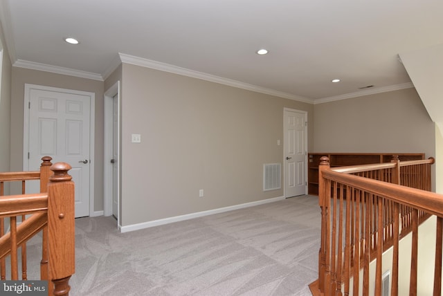 hall featuring crown molding and light carpet