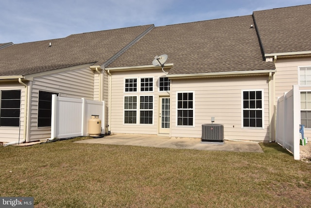 rear view of house with a yard, central AC, and a patio area