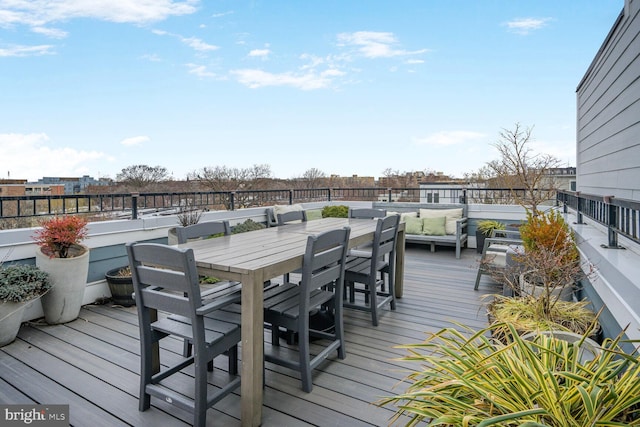 wooden deck featuring outdoor dining area