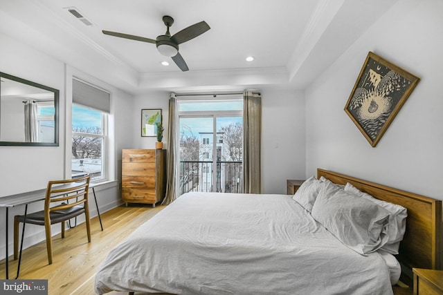 bedroom featuring ornamental molding, multiple windows, visible vents, and light wood-type flooring