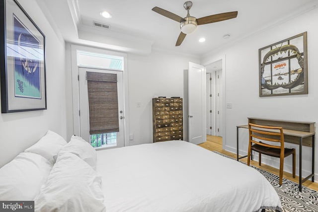 bedroom with visible vents, a ceiling fan, wood finished floors, recessed lighting, and crown molding